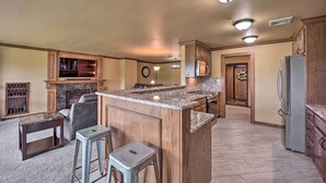 A spacious kitchen with a large island, wooden cabinets, and a built-in oven. - Golf Course & Lake Views: Cozy Afton Condo! (Afton)