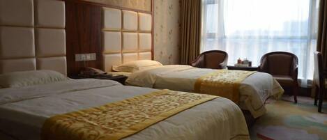 A hotel room with two beds, a large window, and a view of the city.