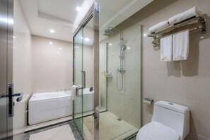 A modern bathroom with a glass-enclosed shower, a bathtub, and a toilet. - National Hotel (Daozhen)