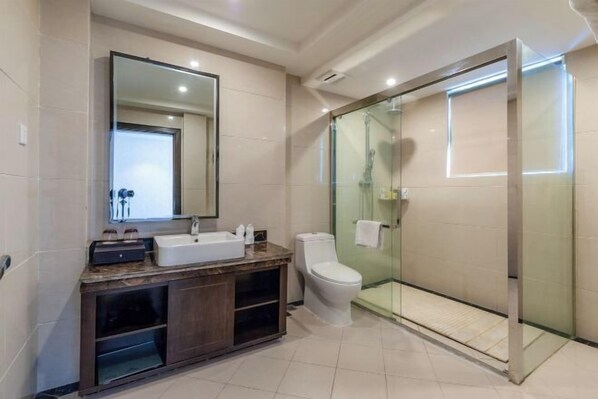 A modern bathroom with a glass-enclosed shower, a large mirror, and a marble countertop. - National Hotel (Daozhen)