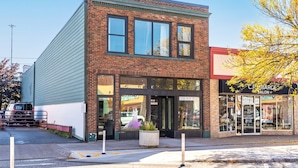 A two-story building with a brick facade and large windows. - Craft District Loft - Michigan (Duluth)