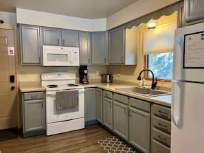 Enjoy cooking in this well-equipped kitchen with a microwave, coffee maker, and refrigerator.