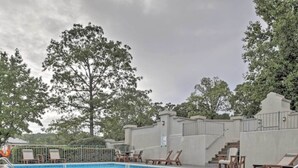 A swimming pool with lounge chairs and a staircase leading to a covered area. - NO STAIRS!  Walk-in condo, Golf Course View, No pets allowed.  (Branson)