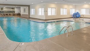 An indoor swimming pool with clear water, a lifeguard chair, and a mural on the wall. - 1 BR Walk in! No Cleaning Fees! Pools/hot tub! WAFFLES! Beach Pass! (Branson)