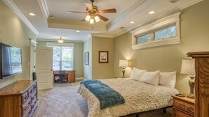 A bedroom with a bed, a desk, a dresser, a ceiling fan, and a window. - Welcoming get-away in the Quiet, Gated Community of Hot Springs Village (Hot Springs Village)