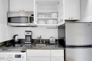 Fridge, microwave, stovetop, coffee/tea maker - Dreamy Back Bay Studio w/ W/D, nr Copley T, by Blueground (Boston)