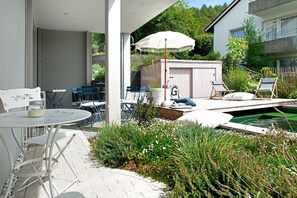 A patio area with outdoor seating, a pool, and a shed.