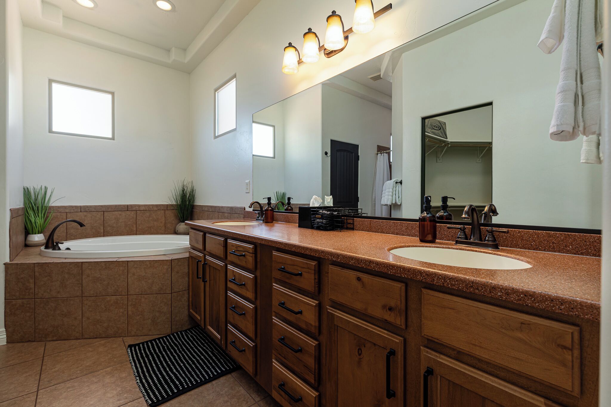 Primary bathroom has double sinks, soaker tub, and large corner shower. 