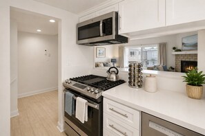 A modern kitchen with a stainless steel stove, a microwave, and a built-in oven.
