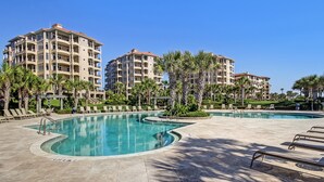 A resort with a large pool area, multiple buildings, and palm trees. - 2nd-Floor Turtle Dunes Unit with Breathtaking Views (Fernandina Beach)