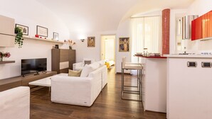 A modern apartment with a living area, a dining area, and a kitchen. - Santamaura Vatican Apartment - 50 meters from the Vatican walls! (Roma)