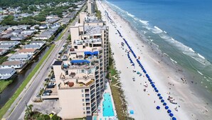 A coastal hotel with a long beachside promenade, a swimming pool, and a view of the ocean. - Perfect 1 Bedroom Oceanfront!! (Murrells Inlet)