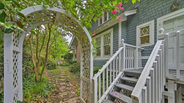 A wooden staircase leading up to a house with a white picket fence and a garden path. - Bright Greensboro Escape ~ 1 Mi to Downtown (Greensboro)