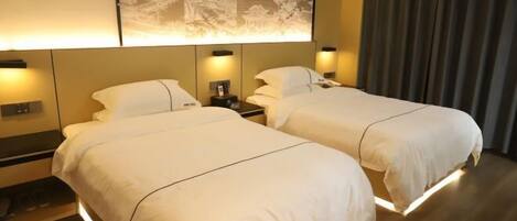 A hotel room with two beds, a large wall mural, and a curtain.