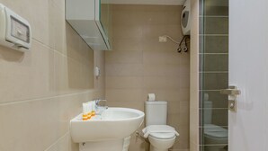 A modern bathroom with a sink, toilet, and glass shower enclosure. - Vesta - Luxury APT - 1BR - Gcribs I (El Gouna)