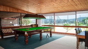 A pool table in a room with wooden ceiling and large windows. - Bluebush Estate - The Lodge (Rothbury)