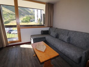 Relax in a serene mountain view room with a comfortable sofa and coffee table.
