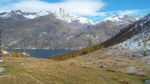 A mountainous landscape with a lake, snow-capped peaks, and a clear sky. - Renovated Studio 2 Pers. Close to Slopes with Balcony (Tignes)