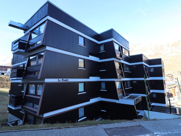 A modern multi-story building with a unique angular design, labeled "Le Pontet."