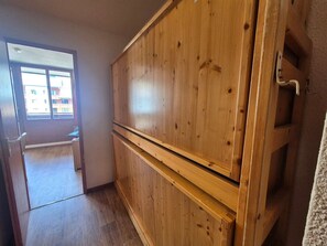 A room with wooden cabinets, a window, and a door leading to another room. - Functional studio close to slopes with balcony, pets allowed (Tignes)