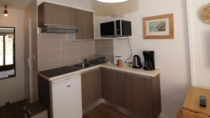 A compact kitchen with a built-in microwave, a coffee maker, and a toaster. - Renovated studio with balcony, near slopes, pets allowed (Tignes)