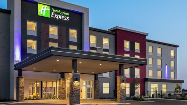 A Holiday Inn Express hotel with a modern facade, large windows, and a covered entrance area. - Holiday Inn Express Strathroy by IHG (Adelaide Metcalfe)