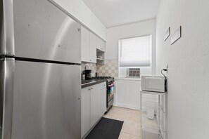 Fridge, microwave, oven, stovetop - Stay in this bright and stylish 1BR in Little Havana, just minutes from Brickell. Enjoy a modern open layout with warm décor, a cozy living area, and a full kitchen. Walk to Calle Ocho cafés, murals, and music, your perfect Miami home base. (Miami)