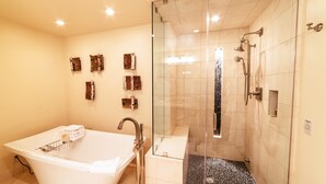 A modern bathroom with a freestanding bathtub, a glass-enclosed shower, and decorative wall art. - Luxury One Bedroom Corner Suite 1 Apartment Hotel by RedAwning (Park City)