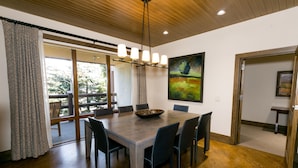 A dining area with a wooden table, chairs, and a chandelier. - Luxury Two Bedroom Corner Suite with Mountain Views 2 Apartment Hotel by RedAwning (Park City)
