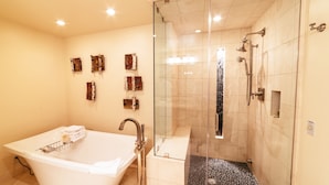 A modern bathroom with a freestanding bathtub, a glass-enclosed shower, and decorative wall art. - Luxury Two Bedroom Corner Suite with Mountain Views 2 Apartment Hotel by RedAwning (Park City)