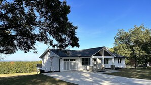 A single-story house with a covered porch, a garage, and a large lawn. - Travelers Rest, Furman, Greenville, and a mountain view! (Travelers Rest)