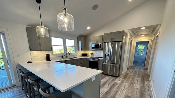 A modern kitchen with a large island, stainless steel appliances, and pendant lighting. - Travelers Rest, Furman, Greenville, and a mountain view! (Travelers Rest)