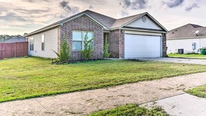 A single-story house with a brick facade, a garage, and a well-maintained lawn. - 8 Mi to Downtown Little Rock: Home w/ Fenced Yard (Little Rock)