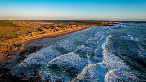 Enjoy breathtaking views of the coastline with the ocean waves gently lapping at the shore.