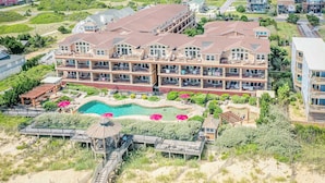 A large resort with multiple buildings, a swimming pool, and a beach area. - Oceanfront 3BR | Indoor & Outdoor Pools + Hot Tub | Pet Friendly | Elevator (Kill Devil Hills)