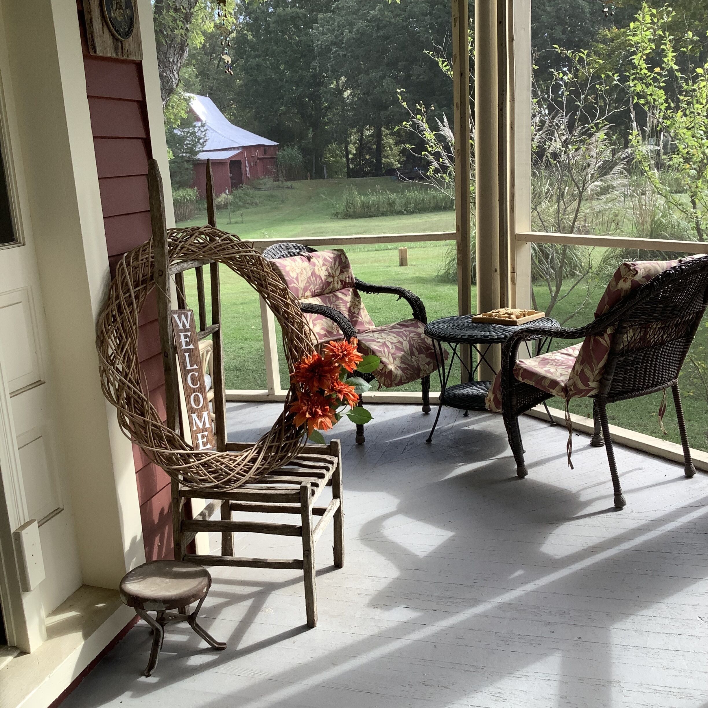 Sitting area front porch looks out to barn & garden