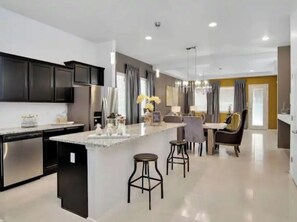 Enjoy meals in the kitchen with a central island, bar stools, and dining area.