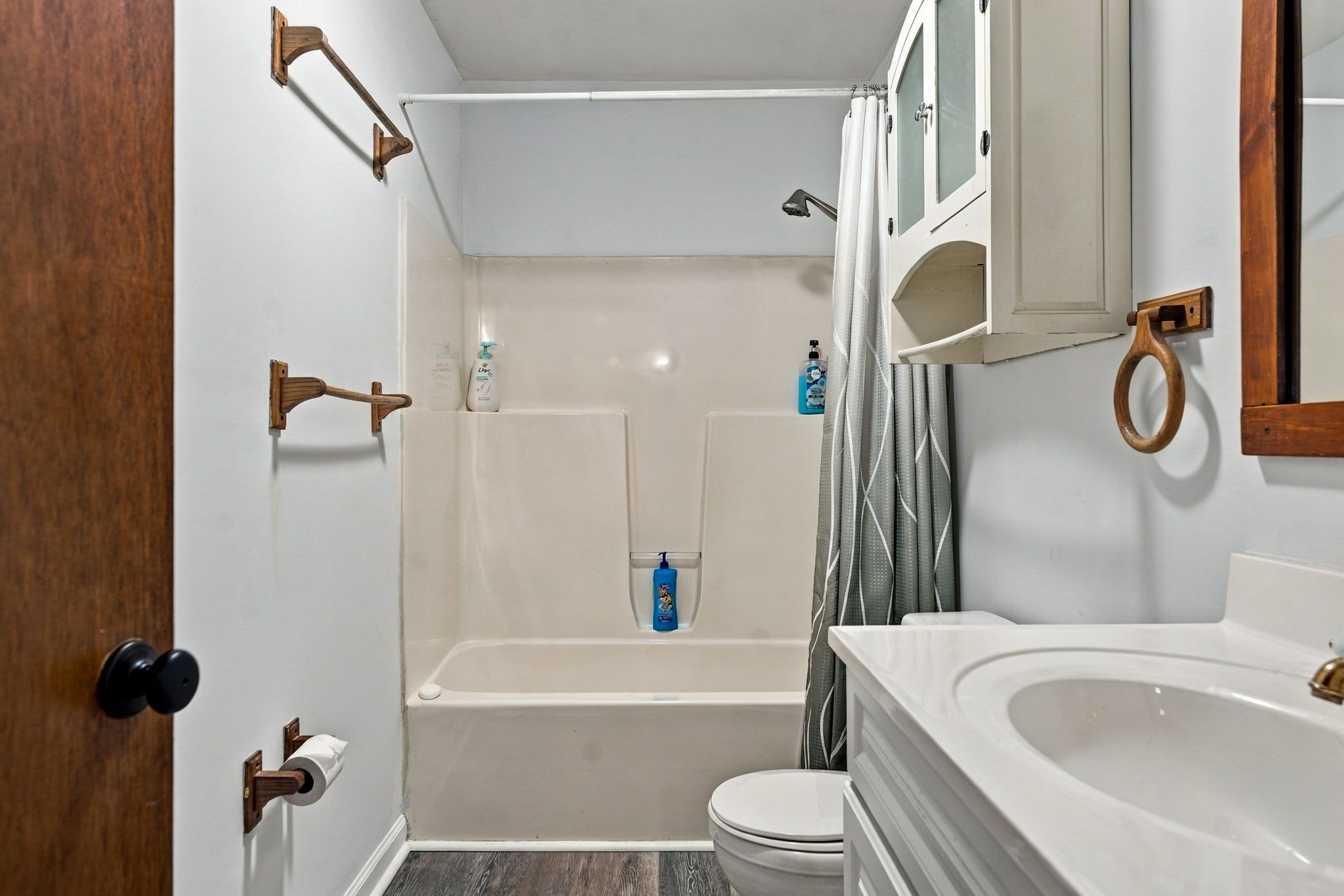 A bathroom with a bathtub, toilet, and sink.