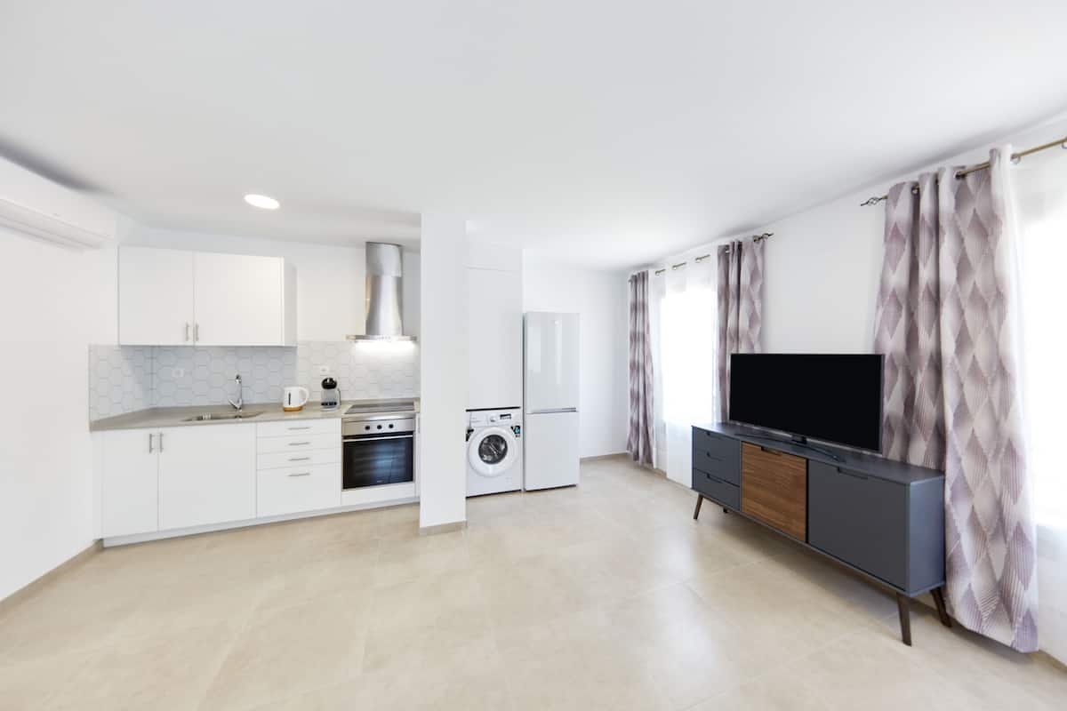 Deluxe appartement | Woonruimte | Een 43-inch smart-tv met kabelzenders