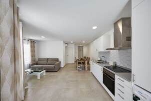 Deluxe Apartment | Living area | 43-inch Smart TV with cable channels