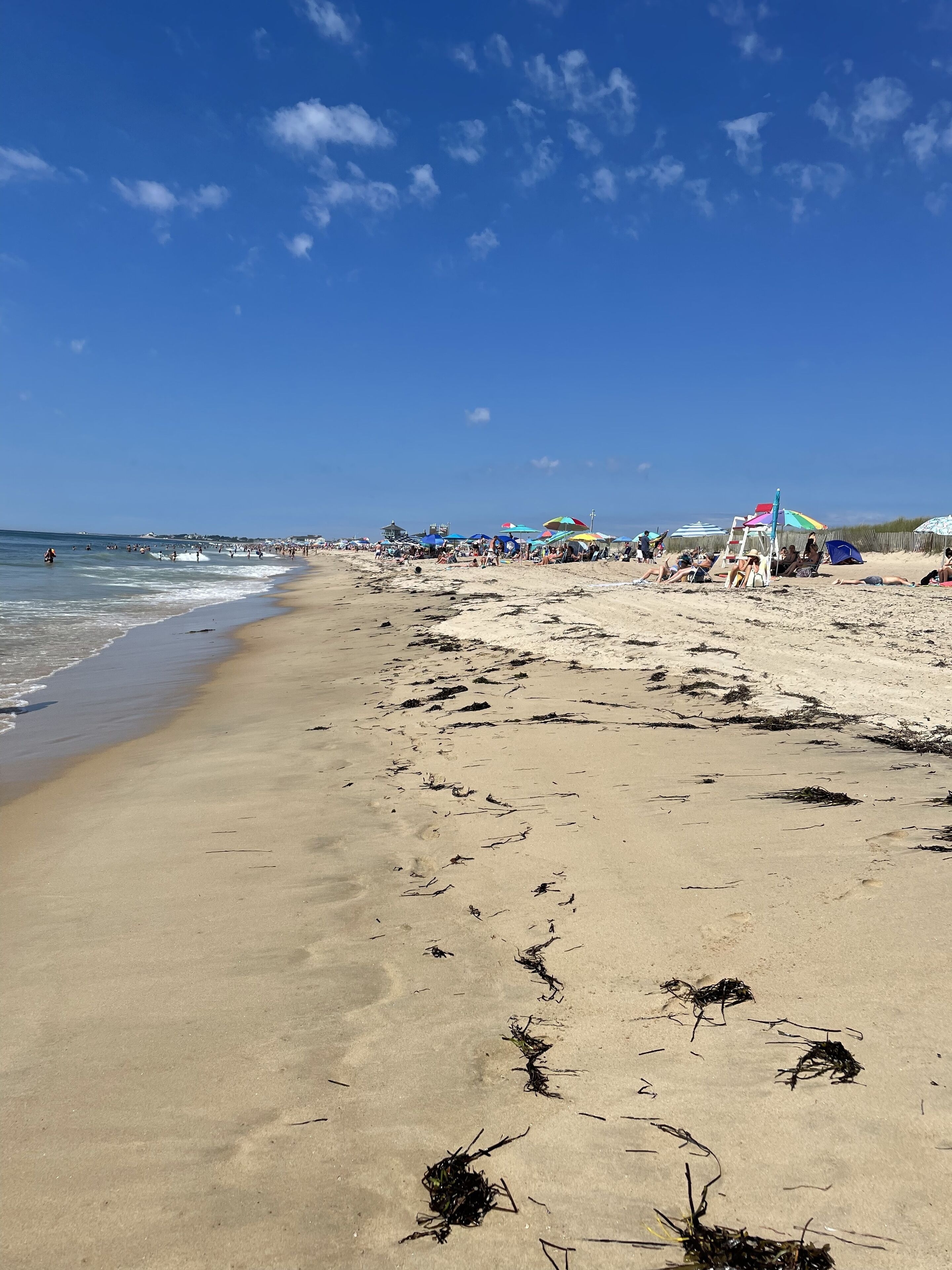 Ranta lähistöllä, aurinkotuoleja, rantapyyhkeitä