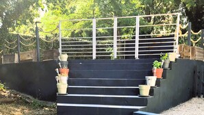 A set of outdoor steps leading up to a gated area with potted plants on either side. - Allegria Nimes (Nîmes)