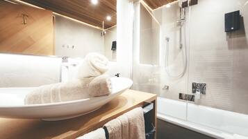 Bathtub, hair dryer, slippers, towels