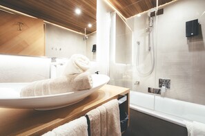 Bathtub, hair dryer, slippers, towels