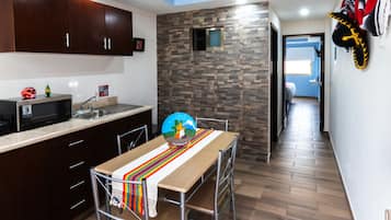 Deluxe Room | Private kitchen | Fridge, microwave