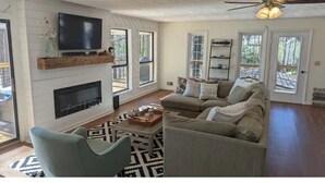 A spacious living room with a fireplace, a television mounted on the wall, a sofa, and a ceiling fan. - Cedar Lake Retreat (Buckhead)
