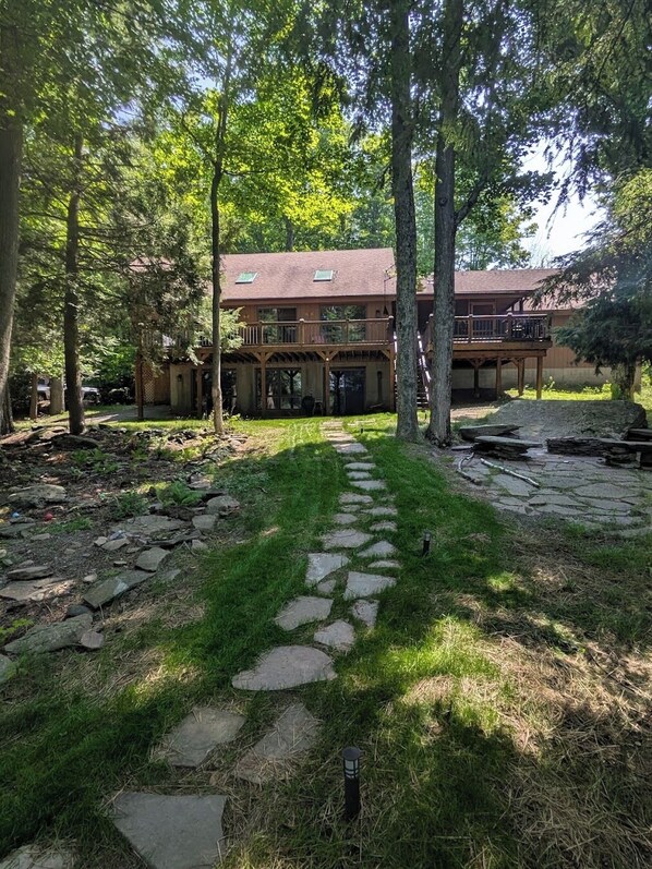 A two-story building with a stone pathway leading to the entrance.