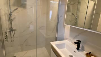 Shower, hair dryer, slippers, towels