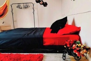 Cozy retreat with a comfortable bed, bicycle, and vibrant decor.