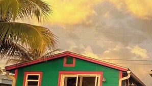 A green house with a red roof and a small window. - Breathtaking Views!  (Matlacha)